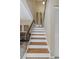 Indoor staircase with wood and white risers, leading to upper level at 2736 Haverhill Ct # 2736, Clearwater, FL 33761