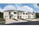 New townhouses with attached garages and landscaping at 31283 Midnight Sun Way, Wesley Chapel, FL 33545