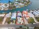 Aerial view of waterfront home with solar panels and boat at 316 16Th Ave, Indian Rocks Beach, FL 33785