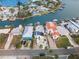 Aerial view of waterfront home with solar panels and boat at 316 16Th Ave, Indian Rocks Beach, FL 33785