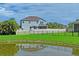Large backyard with pond, gazebo, and patio at 3238 Mela Ct, Holiday, FL 34691