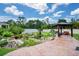 Landscaped backyard oasis with pond and gazebo at 3238 Mela Ct, Holiday, FL 34691
