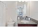 This bathroom features a granite vanity and shower, great for guests at 3238 Mela Ct, Holiday, FL 34691