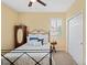 Charming bedroom with a metal bed frame and window shutters at 3238 Mela Ct, Holiday, FL 34691