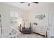 Bright Bedroom featuring a crib and dresser at 3238 Mela Ct, Holiday, FL 34691