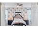Main bedroom with floral wallpaper and a plush bed at 3238 Mela Ct, Holiday, FL 34691