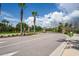 Gated community entrance with palm trees and a curved driveway at 3238 Mela Ct, Holiday, FL 34691