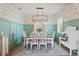 Farmhouse-style dining room with a chandelier and white furniture at 3238 Mela Ct, Holiday, FL 34691