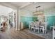 Farmhouse-style dining room with a chandelier and white furniture at 3238 Mela Ct, Holiday, FL 34691