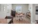 Bright dining area with a round table and chairs, and patterned wallpaper at 3238 Mela Ct, Holiday, FL 34691
