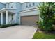 Two-story house with light blue exterior, brown garage door, and porch at 3238 Mela Ct, Holiday, FL 34691