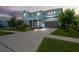 Two-story house, landscaped yard, and driveway at dusk at 3238 Mela Ct, Holiday, FL 34691