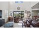 Relaxing Gathering room with high ceilings, leather furniture, and sliding glass doors to a screened porch at 3238 Mela Ct, Holiday, FL 34691