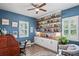 Bright home office features built-in shelving, wood desk, and window seat at 3238 Mela Ct, Holiday, FL 34691