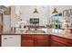 Kitchen island with granite top, sink, and dishwasher; open to living area at 3238 Mela Ct, Holiday, FL 34691