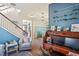 Spacious living room with hardwood floors, comfortable seating, and views to the stairs and dining area at 3238 Mela Ct, Holiday, FL 34691