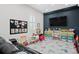 Fun playroom with built-in shelving, a large TV, and a Mickey Mouse theme at 3238 Mela Ct, Holiday, FL 34691