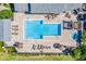 Community pool and spa viewed from above with surrounding patio at 3270 Haviland Ct # 304, Palm Harbor, FL 34684