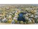 Aerial view showcasing community, lake, pool, and surrounding landscape at 3270 Haviland Ct # 304, Palm Harbor, FL 34684