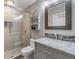 Modern bathroom with gray vanity, marble countertop and shower at 3270 Haviland Ct # 304, Palm Harbor, FL 34684