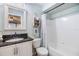 Bathroom with granite countertop, white cabinets and bathtub at 3270 Haviland Ct # 304, Palm Harbor, FL 34684