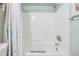 Clean bathroom with a shower/tub combo and white tile at 3270 Haviland Ct # 304, Palm Harbor, FL 34684