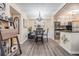 Bright dining area with chandelier and view into kitchen at 3270 Haviland Ct # 304, Palm Harbor, FL 34684