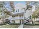 Two-story white building with multiple units and parking at 3270 Haviland Ct # 304, Palm Harbor, FL 34684