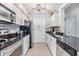 Modern kitchen with stainless steel appliances and granite counters at 3270 Haviland Ct # 304, Palm Harbor, FL 34684