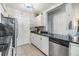 Modern kitchen with stainless steel appliances and granite counters at 3270 Haviland Ct # 304, Palm Harbor, FL 34684