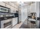Modern kitchen with stainless steel appliances and granite counters at 3270 Haviland Ct # 304, Palm Harbor, FL 34684