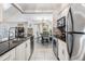 Modern kitchen with stainless steel appliances and granite counters at 3270 Haviland Ct # 304, Palm Harbor, FL 34684
