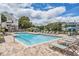 Inviting community pool with lounge chairs and patio at 3270 Haviland Ct # 304, Palm Harbor, FL 34684