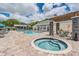 Community pool and hot tub with patio and pergola at 3270 Haviland Ct # 304, Palm Harbor, FL 34684