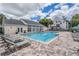 Community pool area with lounge chairs and clubhouse at 3270 Haviland Ct # 304, Palm Harbor, FL 34684