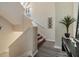 Bright, open staircase with wood-look flooring and neutral walls at 3270 Haviland Ct # 304, Palm Harbor, FL 34684
