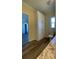 Bathroom with wood-look flooring, built-in linen closet, toilet and vanity with granite countertop at 3729 Winward Lakes Dr, Tampa, FL 33611