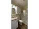 Bathroom featuring a white vanity, granite countertop, medicine cabinet and glass enclosed shower at 3729 Winward Lakes Dr, Tampa, FL 33611