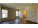 Bedroom featuring wood-look flooring, two windows, and an ensuite bathroom at 3729 Winward Lakes Dr, Tampa, FL 33611