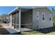 Exterior view of home featuring a screened-in porch and carport at 3729 Winward Lakes Dr, Tampa, FL 33611