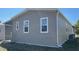 Exterior view of home featuring vinyl siding, white trim and an air conditioning unit at 3729 Winward Lakes Dr, Tampa, FL 33611