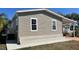 Home exterior features vinyl siding, brick foundation, and a covered carport at 3729 Winward Lakes Dr, Tampa, FL 33611