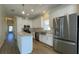 Well-lit kitchen featuring an island, stainless steel appliances, and white cabinetry at 3729 Winward Lakes Dr, Tampa, FL 33611