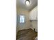 Convenient laundry room with overhead cabinets, a white door and new flooring at 3729 Winward Lakes Dr, Tampa, FL 33611