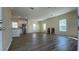 Open floor plan with new vinyl flooring, neutral walls, and stainless steel refrigerator at 3729 Winward Lakes Dr, Tampa, FL 33611