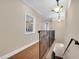 Upstairs hallway with hardwood floors and wrought iron railing at 3817 W Dale Ave # 2, Tampa, FL 33609