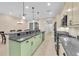 Open kitchen with island, granite countertops, and stainless steel appliances at 3817 W Dale Ave # 2, Tampa, FL 33609
