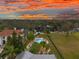 Luxury waterfront home with pool and expansive yard at sunset at 5906 N Kenneth Ave, Tampa, FL 33604