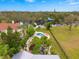 Aerial view of waterfront property with pool and lush landscaping at 5906 N Kenneth Ave, Tampa, FL 33604