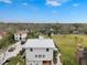 Aerial view showcasing a modern house with metal roof, spacious yard, and waterfront access at 5906 N Kenneth Ave, Tampa, FL 33604